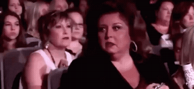 Woman Making Funny Face In Crowd GIF