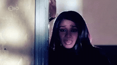 Woman Making Funny Face In Front Of Bar With Bottles GIF