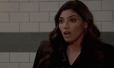 Woman Making Funny Face In Front Of Brick Wall GIF