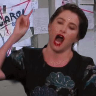 Woman Making Funny Face In Front Of Carol Wall GIF