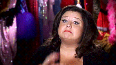 Woman Making Funny Face In Front Of Closet GIF