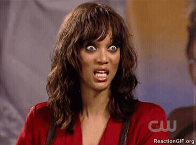 Woman Making Funny Face In Front Of CW Sign GIF