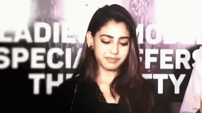 Woman Making Funny Face In Front Of Ladies Special Offer Sign GIF