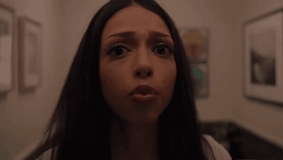 Woman Making Funny Face In Front Of Picture Wall GIF