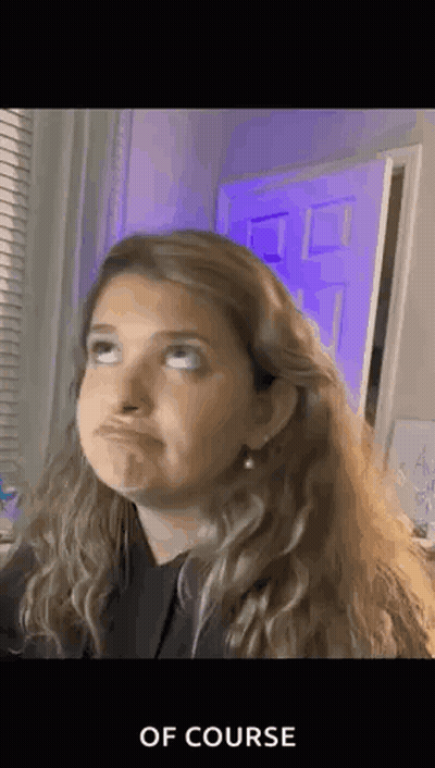 Woman Making Funny Face In Front Of Purple Door And Window GIF