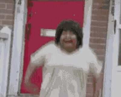 Woman Making Funny Face In Front Of Red Door GIF