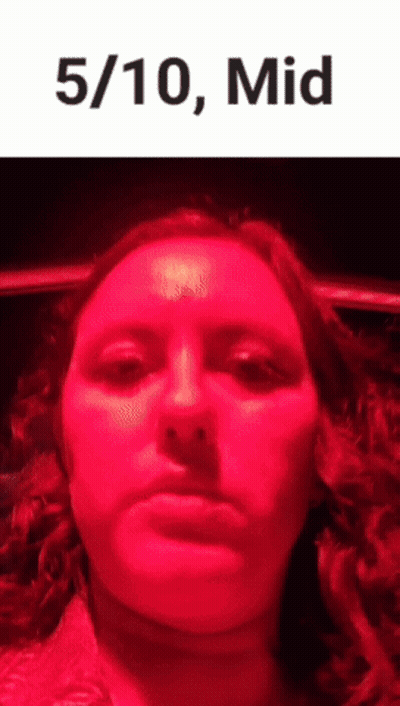 Woman Making Funny Face In Front Of Red Light GIF