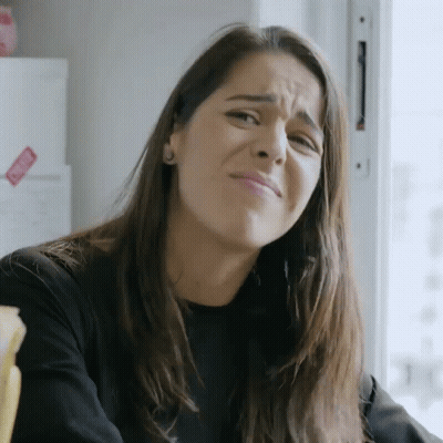 Woman Making Funny Face In Front Of Refrigerator With Sticker GIF