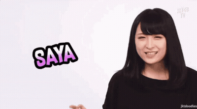 Woman Making Funny Face in Front of Saya Sign