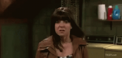 Woman Making Funny Face In Front Of Washing Machine GIF