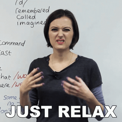 Woman Making Funny Face In Front Of White Board Saying Just Relax GIF