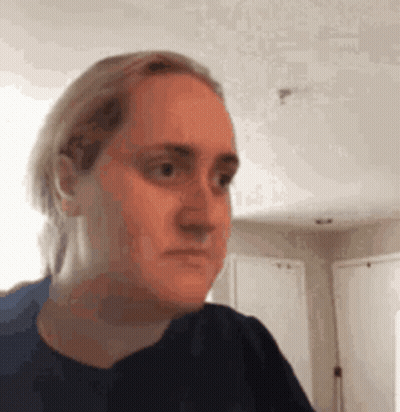 Woman Making Funny Face In Living Room GIF