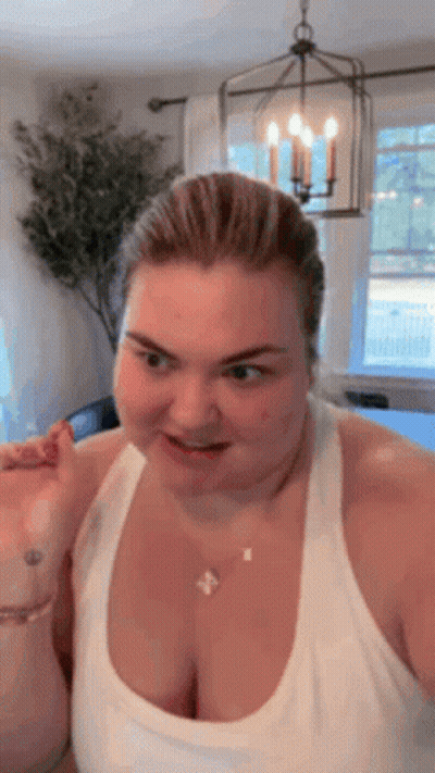 Woman Making Funny Face In White Tank Top GIF