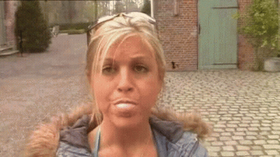 Woman Making Funny Face Wearing Sunglasses GIF
