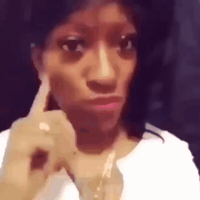 Woman Making Funny Face With Finger GIF