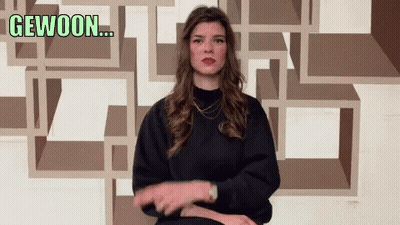Woman Making Gesture With Gewoon Behind Her GIF