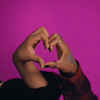Woman Making Heart Shape On Pink Background GIF