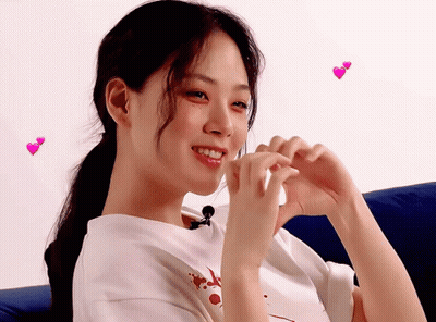 Woman Making Heart With Hands And Flying Hearts GIF