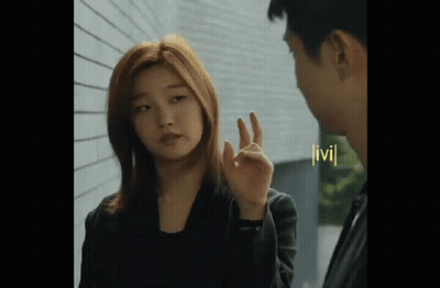 Woman Making OK Sign Next To Man GIF