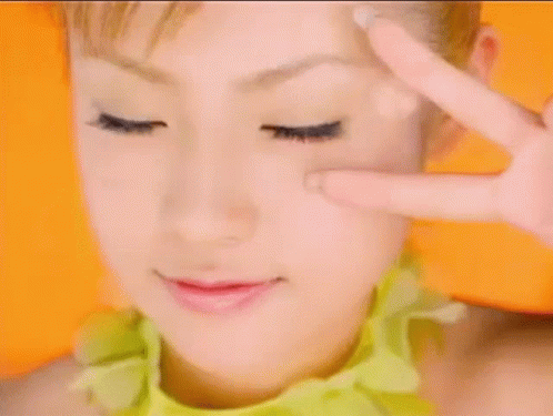 Woman Making Peace Sign GIF