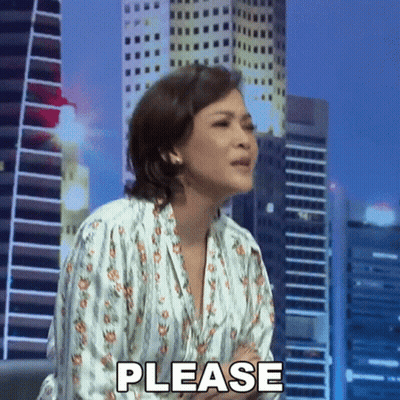 Woman Making Please Gesture In Front Of City Skyline GIF