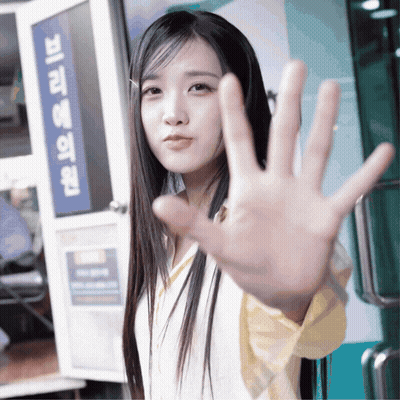Woman Making Stop Sign In Front Of Korean Sign GIF