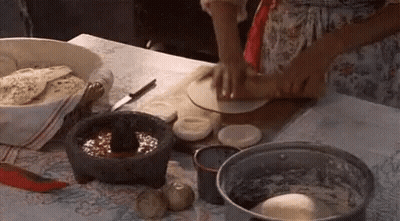 Woman Making Tortilla On Table GIF