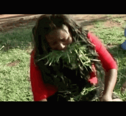 Woman Munching On Grass GIF