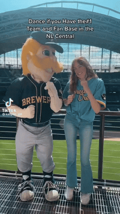 Woman Next To Brewers Mascot On Balcony GIF