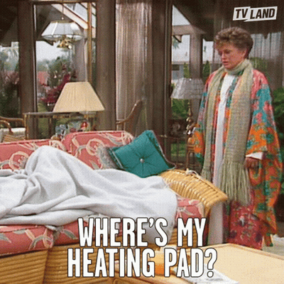 Woman Next To Couch Saying Where's My Heating Pad GIF
