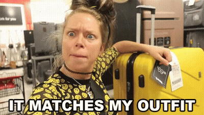 Woman Next To Yellow Suitcase Saying It Matches My Outfit GIF