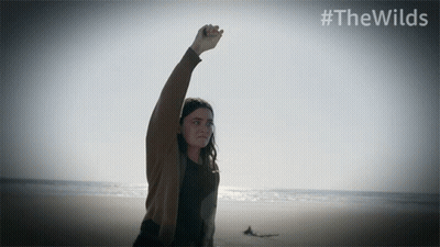 Woman On Beach With Fist In Air #Thewilds GIF
