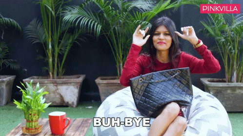 Woman On Bean Bag With Black Purse Buh-Bye GIF