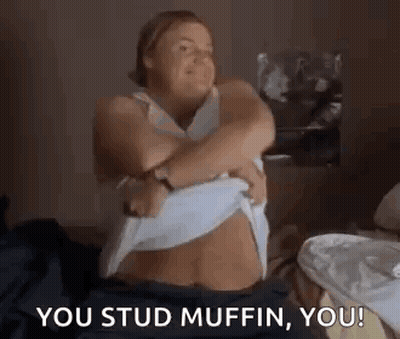 Woman On Bed Taking Off Shirt Saying You Stud Muffin GIF