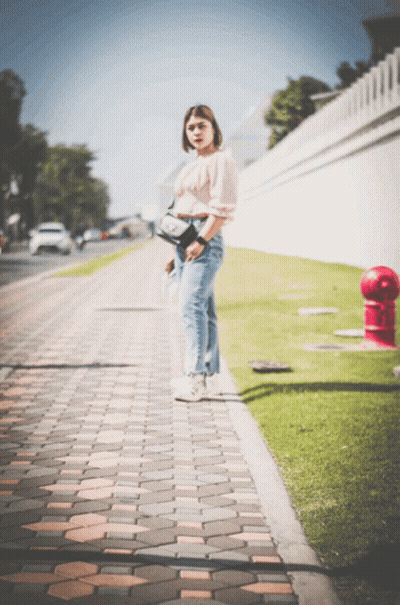Woman On Brick Sidewalk Near Red Fire Hydrant GIF