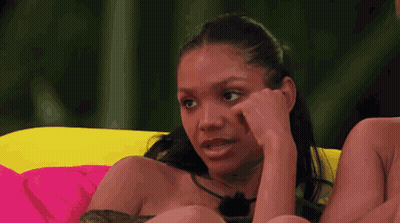 Woman On Couch Hand To Face GIF