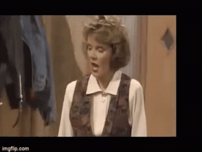 Woman On Couch Holding Bag Saying A GIF
