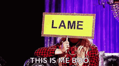 Woman On Couch Holding Lame Sign GIF