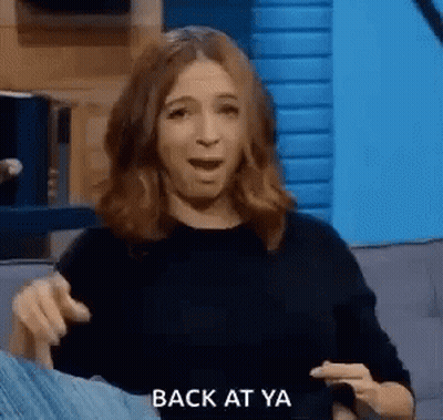 Woman On Couch Making Funny Face Pointing GIF