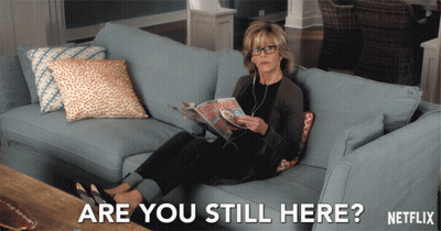 Woman On Couch Reading Magazine Saying Are You Still Here GIF