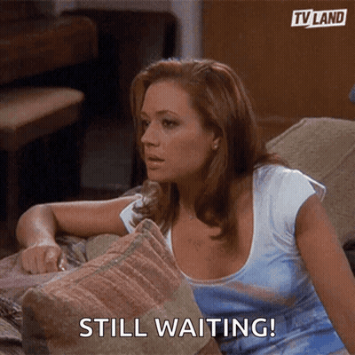 Woman On Couch Saying Still Waiting GIF