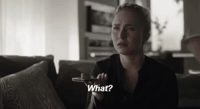 Woman On Couch Talking On Cell Phone Saying What GIF
