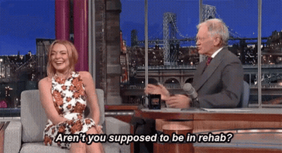 Woman On Couch Talking To Man In Suit GIF