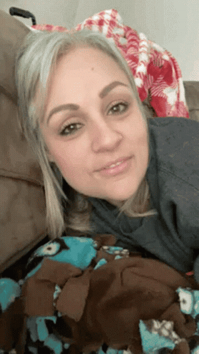 Woman On Couch With Blanket Smiling GIF