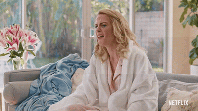 Woman On Couch With Netflix Blanket GIF