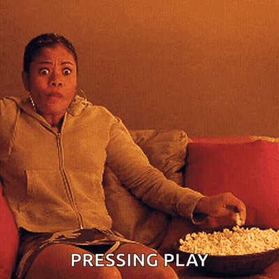 Woman On Couch With Popcorn Pressing Play GIF