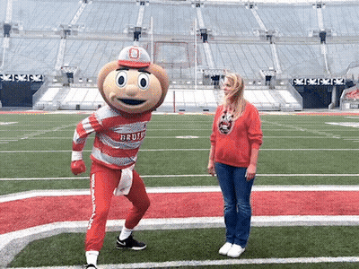 Woman On Football Field With Buckeyes Mascot GIF