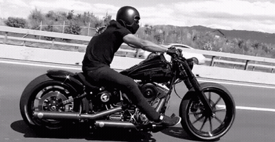 Woman On Motorcycle Next To Standing Woman GIF