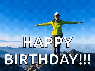 Woman On Mountain Arms Outstretched Saying Happy Birthday GIF