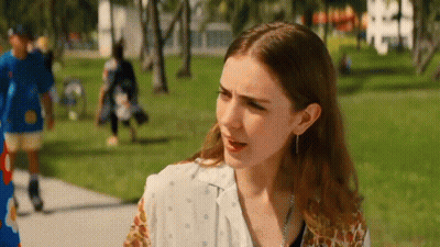 Woman On Sidewalk In Park With Man In Blue Shirt GIF